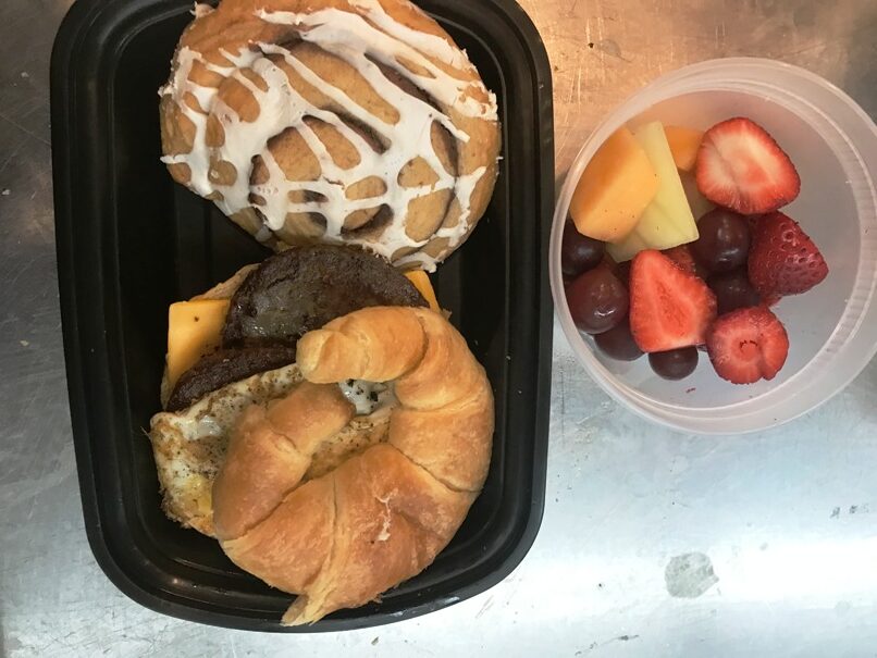 Breakfast croissant sausage egg and cheese Pastry and fruit